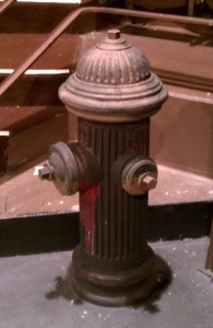 The finished fire hydrant onstage under work lights.